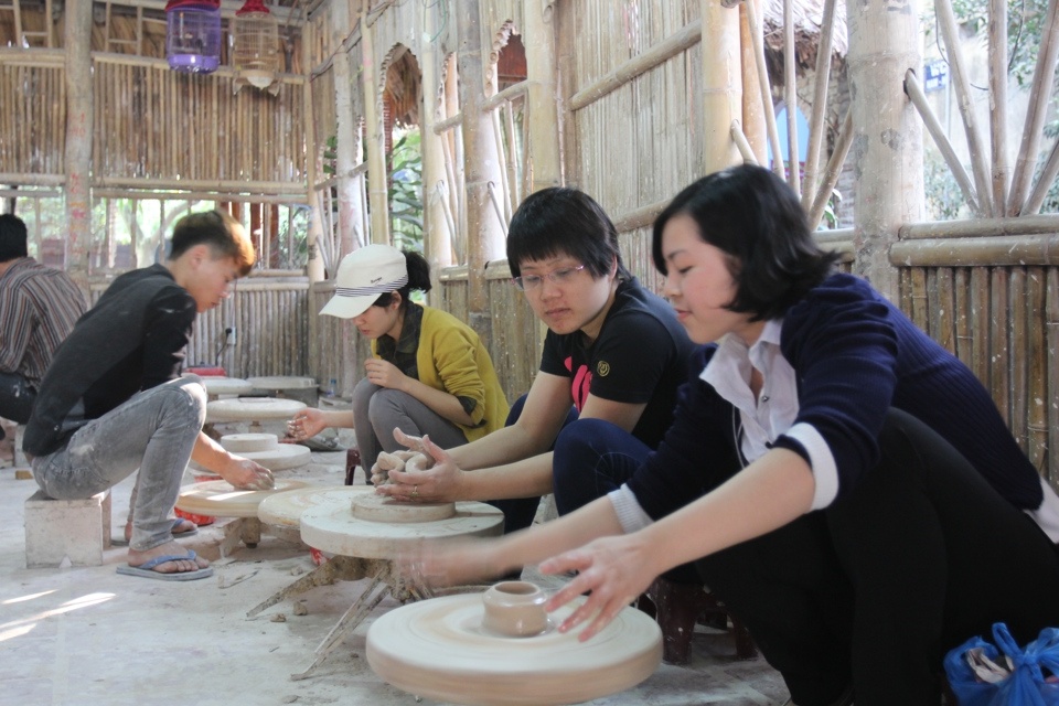 Khách du lịch trải nghiệm làm sản phẩm tại làng nghề gốm sứ Bát Tràng. Ảnh: Hải Linh