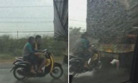 [VIDEO] Đôi nam nữ "liều mạng" bám đuôi xe tải để tránh mưa