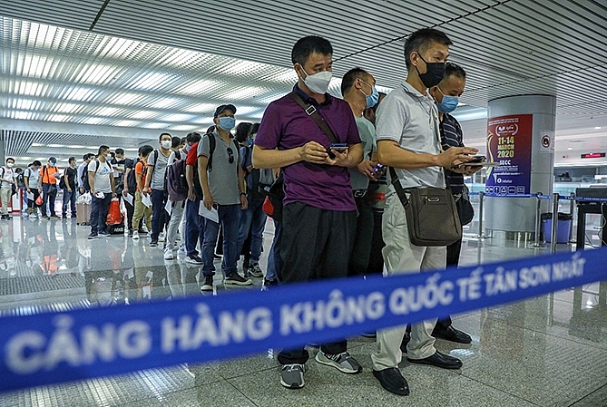 Hành khách nhập cảnh làm thủ tục kiểm dịch tại sân bay Tân Sơn Nhất năm 2020. Ảnh: VNE